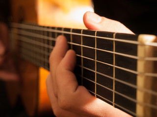 Musician playing classic guitar, backfill flash