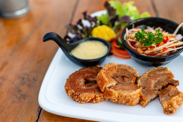 Spicy mango, salad paired with crispy pork appetizing