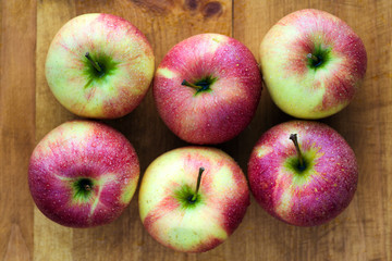 juicy red-yellow apples on an old wooden table