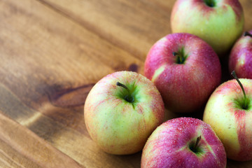 juicy red-yellow apples on an old wooden table