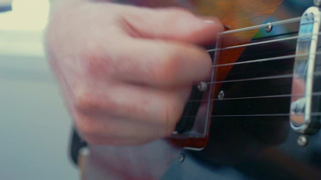Close up playing electric guitar