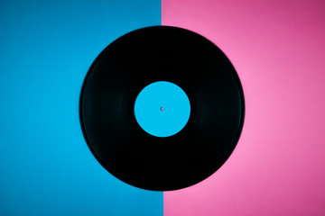 Old vintage record on a colored background.Music background.