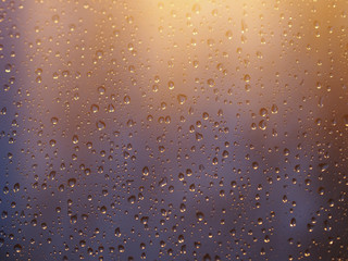 vintage color tone of Water and rain drops on the glass, abstract view, Drops of rain on blue glass background / drops on glass after rain. Image has shallow depth of field.