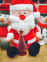 Doll cute santa claus and red christmas tree decorated celebrate the Christmas festival. xmas background