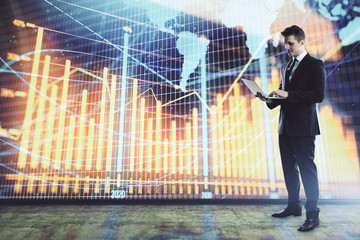 Businessman and forex graph and world map hologram. Double exposure. Concept of financial education and analysis