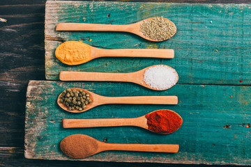 flat lay of spices in wooden spoon on table