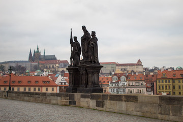 Obraz premium A masterpiece of architecture the famous Charles Bridge in the city of Prague, Czech Republic, on a cloudy morning on the eve of Christmas.