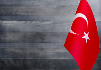 Fragment of the flag of Turkey in the foreground blurred light background copy space