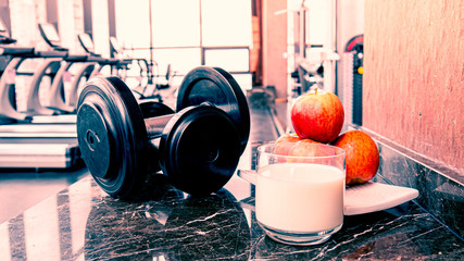 Fitness room in the morning with apple fruit and milk , Concept for healthy lifestyle
