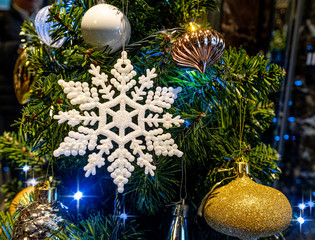 Christmas decoration with artificial white snowflake and golden ball with background lighting