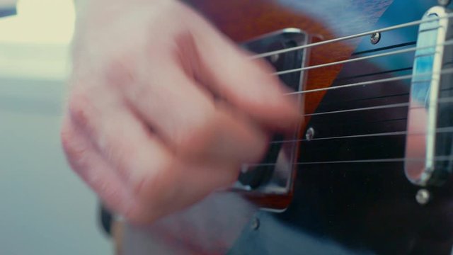 Close up playing electric guitar