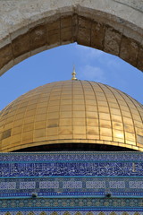 dome of the rock in jerusalem, golden cupola in frame pf stony arch, decorative facade of the temple