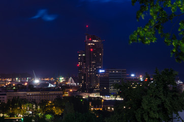 Fototapeta na wymiar NIGHT OVER THE PORT CITY - City landscape in the night illumination