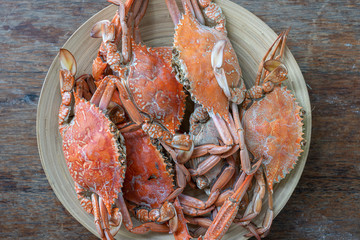Boiled crabs on plate in beach cafe on the island of Zanzibar, Tanzania, Africa, close up, top view