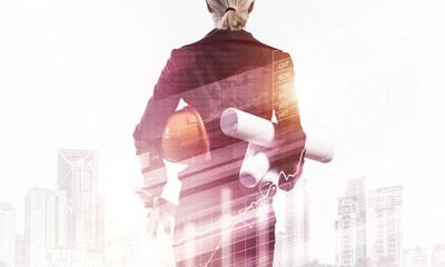 Woman architect with technical blueprints