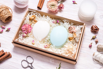 Natural homemade soap in cardboard box on wooden table