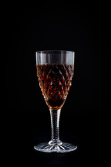 Oloroso sherry in a cut crystal sherry glass isolated on a black background