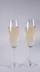 Two glasses with champagne on a white background