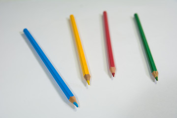 Four Color pencil on a white background Blue yellow red green Colors