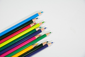 random color colour pencils in diagonal shape on a white background