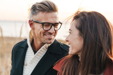 Beautiful smiling couple wearing autumn clothing