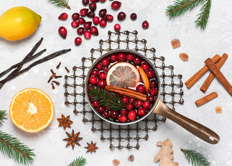 Homemade mulled wine hot drink with cranberries, citrus, orange and spices in aluminum casserole...