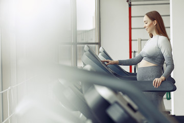 Pregnant girl in a gym. Sports girl in a sportswear.