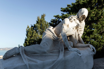 Statue of Christ and Mary at the Notre Dame de la Garde in Marseille against a bright blue sky on a...