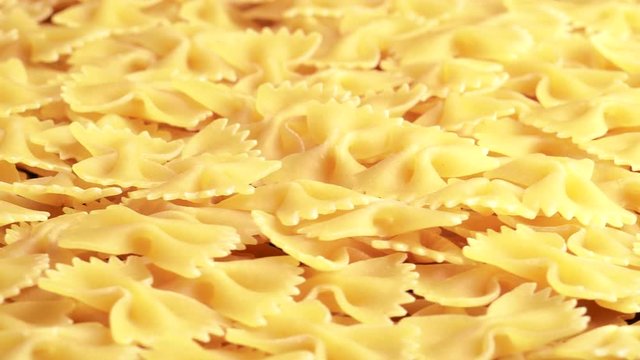 Pile of raw italian farfalle pasta in motion
