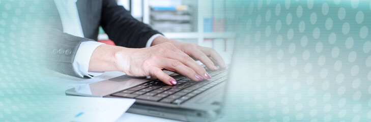 Businesswoman typing on a laptop; panoramic banner