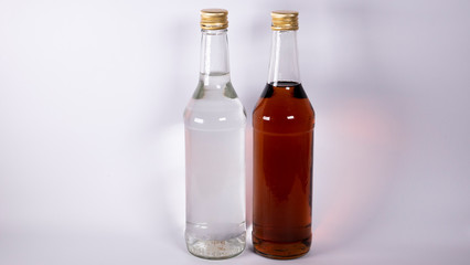 Bottles with cognac, whiskey and vodka on a white background