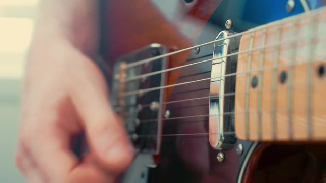 Close up playing electric guitar