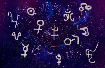 Fototapeta na wymiar Astrological symbols and zodiac signs and planets on a wall background.