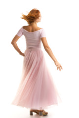 Naklejka premium A beautiful young woman stands in the wind, the wind moves her c