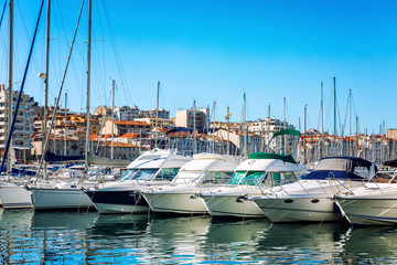 Snow-white sailing yachts in a marina in Marseille on a bright sunny day. Beautiful view.
