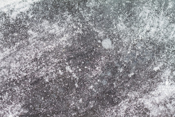 Textured ise of frozen lake. White snow on the surface. Winter template.