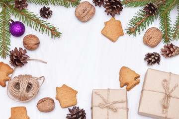 Christmas composition. Xmas gingerbread cookies, cookies in shape of houses,  fir branches, gifts on white background. New year 2020. Flat lay, top view, copy space.