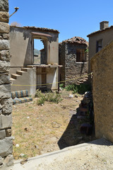 Fototapeta na wymiar Ruined house in the abandoned Greek village Derekoy (Schinoudi) - turkish aegean island Gokceada, Aegean Sea, Turkey, Europe