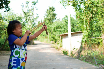 Children are having fun playing by shooting rubber bands.