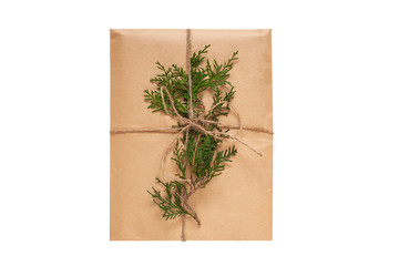 Eco gift box wrapping in kraft paper on white background isolated. Vintage eco-friendly natural style. Composition with present decorated with Christmas tree branches. Top view,New year flatlay,mockup