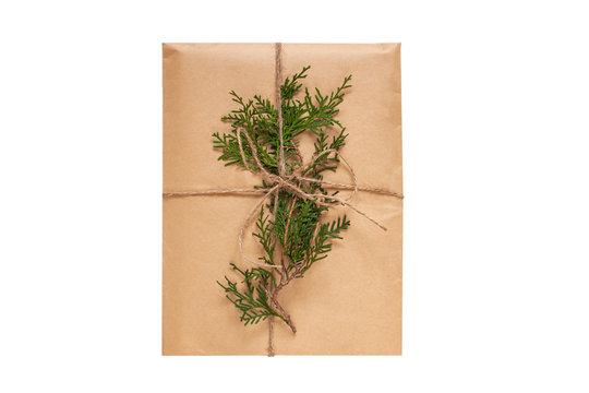 Eco gift box wrapping in kraft paper on white background isolated. Vintage eco-friendly natural style. Composition with present decorated with Christmas tree branches. Top view,New year flatlay,mockup © KawaiiS