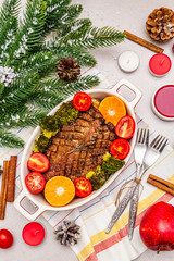 Baked duck breast on the bone with vegetables and sauce. Christmas dinner concept, New Year table setting. Stone concrete background