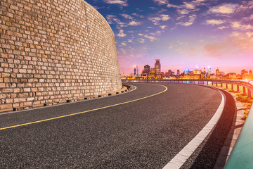 Night asphalt road and city skyline in Shanghai