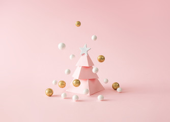 Christmas composition. Pink Christmas tree, with decoration on pink background. Happy holidays. new...