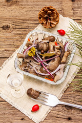 Pickled (fermented) mushrooms. Traditional New Year (Christmas) snack. Festive table cutlery setting