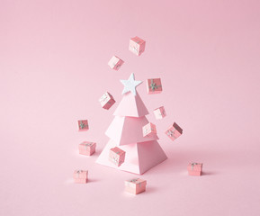 Christmas composition. Pink Christmas tree, with presents on pink background. Happy holidays. new year minimal concept.