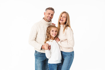 Image of caucasian family in winter clothes hugging together and smiling