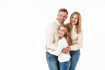 Image of caucasian family in winter clothes hugging together and smiling