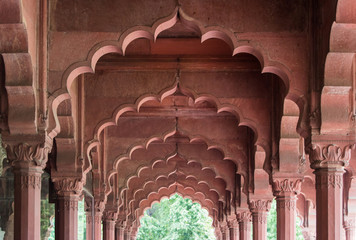 Red columns in perspective from inside a hall in Red Fort, New Delhi