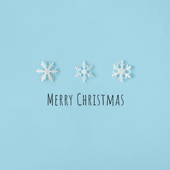 Creative Snowflakes hat with bright blue background. Minimal winter flat lay Christmas concept. Merry Christmas